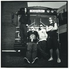 three people standing in front of a bus