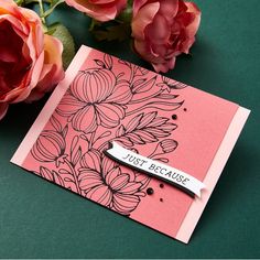 a pink card with flowers and a name tag