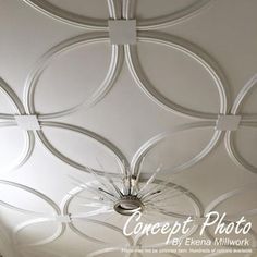 the ceiling is painted white and has circular designs on it, as well as a chandelier