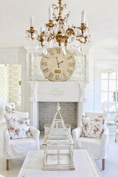 a living room filled with furniture and a large clock on the wall above it's fireplace