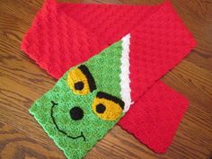 two crocheted dishcloths on top of a wooden table