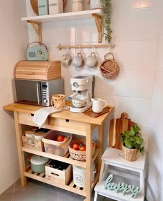 a kitchen area with coffee maker, microwave and other items