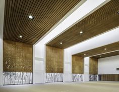 an empty room with wood paneling and white walls