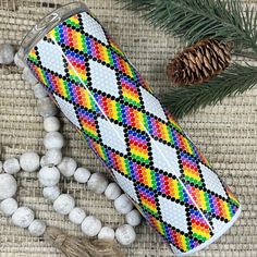 a colorful case sitting on top of a table next to some balls and pine cones