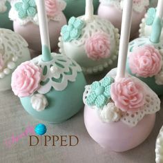 there are many cake pops decorated with flowers and laces on the top of them