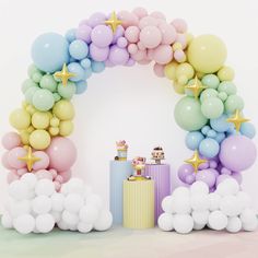 there are balloons and presents in front of the arch that is made out of balloons