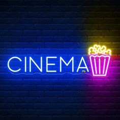 a neon sign that says cinema with a cup of popcorn on the side in front of it