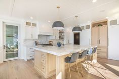 a large kitchen with an island in the middle and lots of counter space on one side