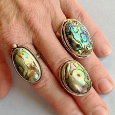 Do you love a statement ring? Abalone, also known as paua shell is sure to stand out. Abalone, also known as Paua, is the shell of a sea snail. The thick inner layer of the shell is composed of mother-of-pearl, which in many species is highly iridescent, giving rise to a range of strong, changeable colors, especially blue and green. It is truly a treasure of the ocean. In addition, each abalone shell is unique in pattern and color. I create a decorative accent with a twisted square wire around t Silver Shell Rings For Gift, Unique Silver Shell Rings, Unique Sterling Silver Shell Jewelry, Unique Abalone Shell Jewelry, Unique Shell-shaped Silver Jewelry, Unique Silver Shell-shaped Jewelry, Adjustable Sterling Silver Shell-shaped Jewelry, Adjustable Shell-shaped Sterling Silver Jewelry, Handmade Vintage Abalone Shell Jewelry