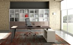 an office area with a desk, bookcases and chair in it's center