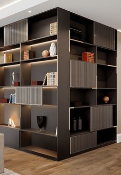 a living room filled with lots of bookshelves next to a fire place on top of a hard wood floor