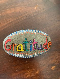 a rock with the word gratitude painted on it