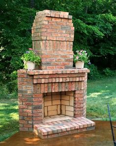 an outdoor brick fireplace with potted plants on top