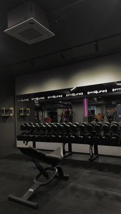 an empty gym with rows of exercise equipment