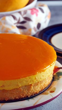 a close up of a cake on a plate with the words mango mousse cake