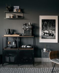 a black and white photo hangs on the wall next to a table with two chairs