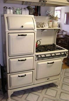 an old fashioned white stove in a kitchen