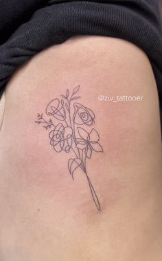 a woman with a tattoo on her stomach has a flower in the shape of a heart