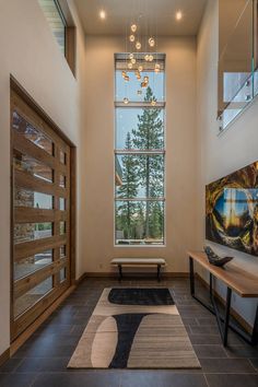 a long hallway with a bench and large window