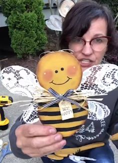 a woman is holding a small bee in her hands