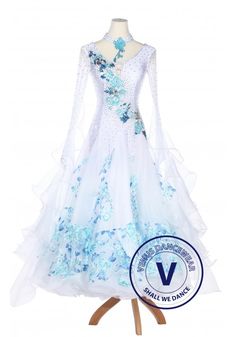 a white and blue dress on a mannequin with an award seal in the background