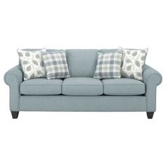 a blue couch with plaid pillows on it's arms and back cushions, against a white background