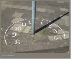 an image of a clock on the ground with numbers painted on it's sides