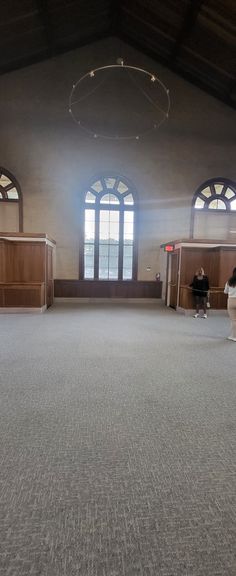 an empty room with two people sitting in chairs