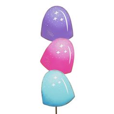 three colorful candy lollipops sitting on top of each other in the shape of stars