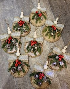 christmas decorations are arranged on baskets with pine cones, berries and bells in the center