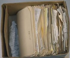 an open file box filled with files and papers