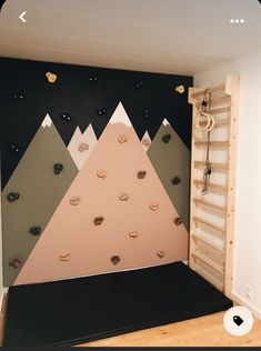 a room with a climbing wall in the corner