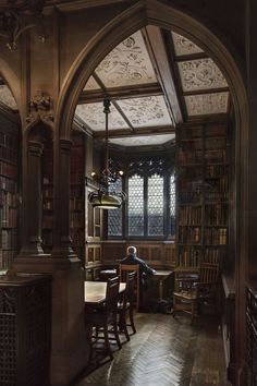 a person sitting at a table in a library