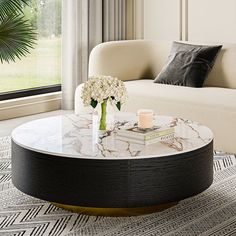 a marble coffee table with flowers on top