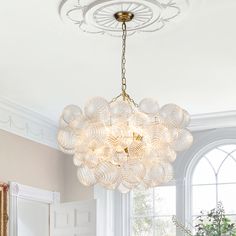 a chandelier hanging from the ceiling in a dining room