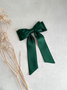 Premium quality duchess satin slim hair bow with tails in forest green. This stylish hair bow is an ideal hair accessory for wearing to a special occasion or even everyday wear. 🎁It will also make a great "gift for girl." They are handmade with love and care from  high quality fabric in our studio in England. 📍Available in different attachments: ✅Barrette  ✅Comb Slide ✅Alligator Clip 📍If you need this in a different attachment that isn't listed, please feel free to message me.  📏Bow measurem Forest Green Accessories, Dark Green Ribbon, Short Shoulder Length Hair, Satin Hair Bow, Dark Green Hair, Junior Prom, Gift Bow, Green Accessories, Double Bow