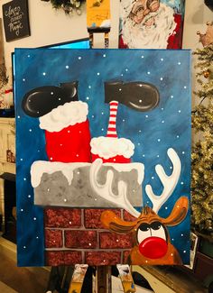 a painting of santa and reindeer on a brick wall