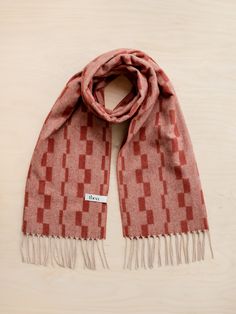 Elevate your outfit with a fringed TBCo lambswool scarf featuring a stacked checker pattern in a blend of rust and red. Taking the best from both, it's a modern combination of our well-loved striped and checkerboard designs. It's woven from pure lambswool, which is famously insulating, warm, breathable, sustainable and beautifully soft. Materials: Fibre, 100% Lambswool. Size: 20" x 79" / 50cm x 200cm, including fringing Care: Handwash. Lay Flat to Dry. Designed in Edinburgh Studio. Alpaca Blanket, Checker Pattern, Luxury Gifts For Her, Sleep Accessories, Cashmere Blanket, Stocking Filler Gifts, Pajamas Gift, Inner Mongolia, Triangle Scarf