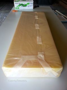 the mattress is wrapped in plastic and ready to be put into the bed frame for storage