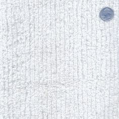 a white towel with a blue button on it