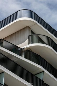 an unusual building with balconies on top