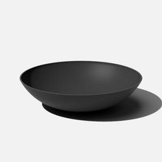 a black bowl sitting on top of a white table