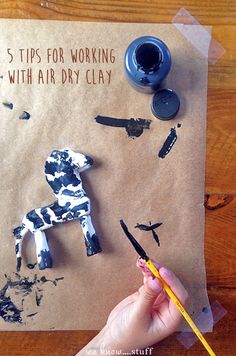 a child's hand is holding a pencil and drawing on paper with the words 5 tips for working with dry clay