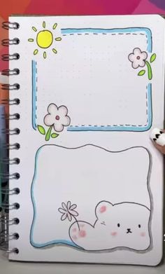 an open notebook with a drawing of a bear and flowers