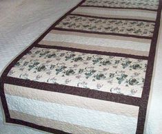 a quilted bed spread with flowers on it