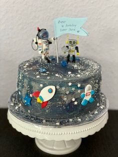 a birthday cake with an astronaut and rocket on top