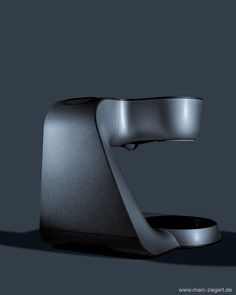 a black and silver object on a gray background with the light reflecting off it's side