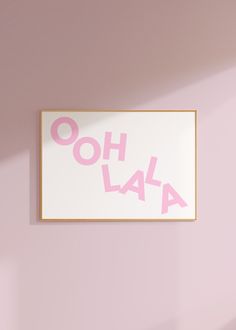 a pink and white poster with the word oh laa on it hanging up against a wall