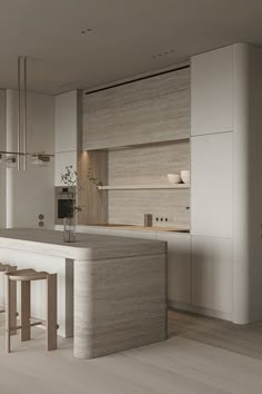 a modern kitchen with an island counter and stools