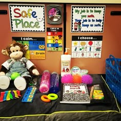 a stuffed monkey sitting on top of a bed next to other toys and decor items